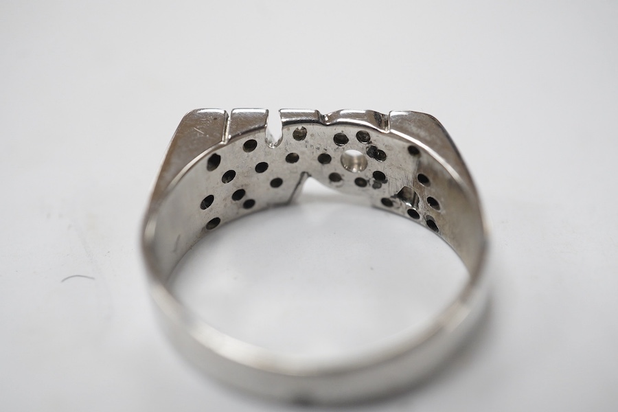 A white metal and diamond chip cluster set 'LOVE' ring, size J, gross weight 3.4 grams. Condition - fair